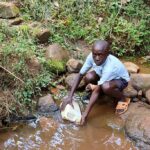 Kenya22258-Clonton-fetching-water-1024x683